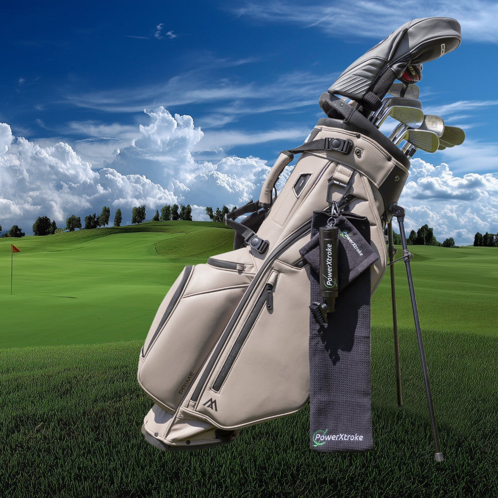 Golf bag with PowerXtroke kit showing sprays, brush and microfiber towels clipped to the bag — the perfect setup for clean and polished clubs.
