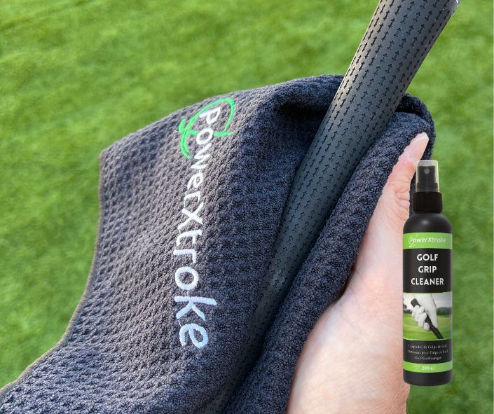 Cleaning a golf grip with towel and PowerXtroke spray – restores tackiness and removes grime